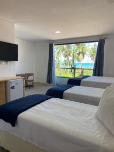 Ένα ή περισσότερα κρεβάτια σε δωμάτιο στο Pousada Canouan