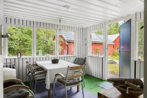 a dining room with a table and some windows at HAL657-Knaered-Bjoerkered-72 in Körsveka