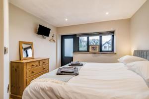 a bedroom with a bed and a dresser and a mirror at 3 Bed in Dulverton oc-t32975 in Dulverton