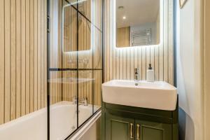 a bathroom with a sink and a mirror and a tub at 3 Bed in Dulverton oc-t32975 in Dulverton +24 photos