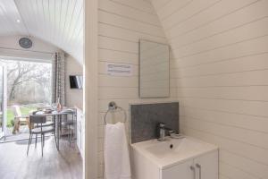 a white bathroom with a sink and a table at 1 Bed in Llanfyllin oc-p29023 in Llanfyllin