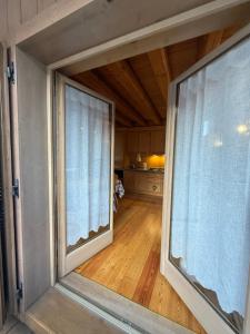 a view of a room with two large windows at Precumon 8'1 in Arabba