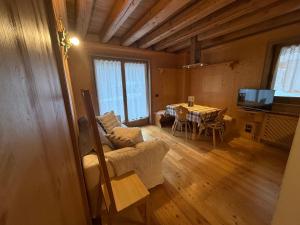 a living room with a table and a dining room at Precumon 8'1 in Arabba +18 photos