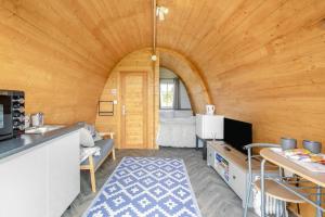 a kitchen and living room in a wooden room at 1 Bed in Four Lanes oc-b32769 in Carnbrea