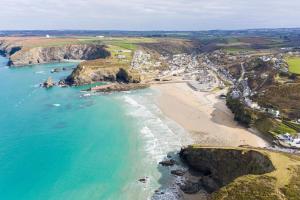 an aerial view of a beach with the ocean at 1 Bed in Four Lanes oc-b32769 in Carnbrea