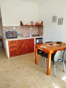 a kitchen with a wooden table and a microwave at Amaru Apart in Cafayate +20 photos