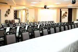 a conference room with a long table and chairs at Готель Релакс in Korostyshiv