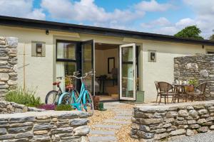 a blue bike parked in front of a house at Dromquinna Manor in Dunkerron Islands