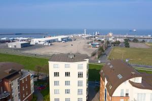 an aerial view of a white building and the ocean at Nordseeblick 5 in Cuxhaven +9 photos