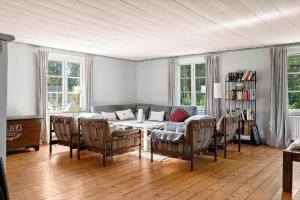 a living room with a couch and a table and chairs at KAL558-Virserum-Holm-6 in Holm