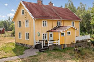 a yellow house with a red roof at KAL558-Virserum-Holm-6 in Holm