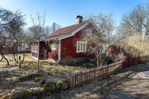 Una vieja casa roja en un campo con una valla. en KAL529-Virserum-Dala-5, en Virserum