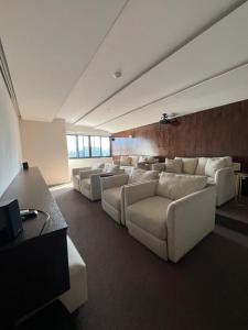 a living room with white couches in a room at Comfortable apartment in Acacias, San Ignacio in Tegucigalpa