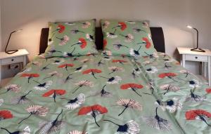 Ferienwohnung am Wall في سوست: سرير مغطى بغطاء عليه رسومات طيور ومظلات