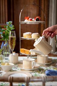 a table with a tea kettle on a table with a cake at Buxted Park Hotel in Uckfield