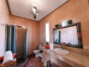 a bathroom with a sink and a mirror at Villa Essalah & Spa Marrakech in Marrakech