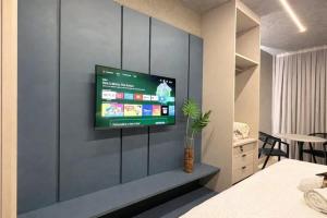 a room with a television on a wall at Setai Yatch - Praia in João Pessoa +22 photos