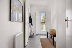a hallway with white walls and white floors and a door at OGO781-Mjoelby-Norrby-Naesloesegard-1 in Mjölby