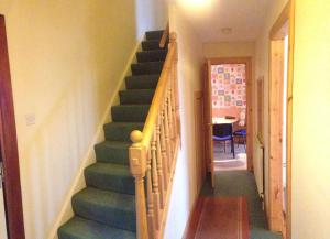 a staircase with green steps in a house at House for Groups & Contractors Kilmarnock in Kilmarnock