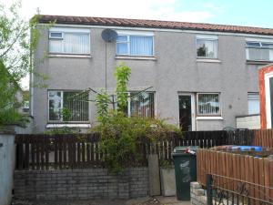 a house with a fence in front of it at House for Groups & Contractors Kilmarnock in Kilmarnock