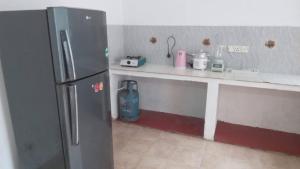 a kitchen with a counter and a refrigerator at New Moon in Maharagama