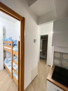 een kleine kamer met een stapelbed en een keuken bij Casa Emma in Costa Rei
