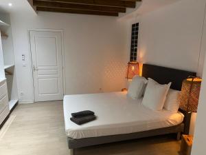 a bedroom with a bed with a black towel on it at Villa fleurs d'Antalia in Anse-Bertrand +47 photos