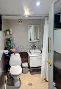 a bathroom with a toilet and a sink at Guest House Marina in Tbilisi City +53 photos