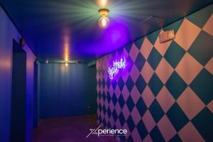 a room with a purple light on a wall at Teal at 12, City Views and Wonderland Vibes! in Hatillo
