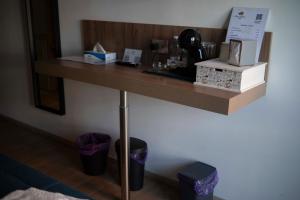 a wooden shelf on a wall with items on it at Rosa Rooms Pompei in Pompei