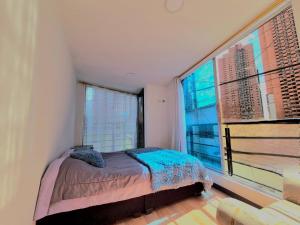 En eller flere senge i et værelse på Espectacular Apartamento en San Martín