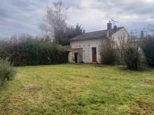 a small white house with a grass yard at Gîte des Fraignaies in Saint-Juire-Champgillon