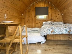 a bedroom with a bed in a wooden cabin at Meadow - Uk48483 in Dalton in Furness