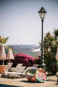 Ein paar Liegestühle und eine Straßenlaterne mit einem Surfbrett in der Unterkunft Posada del Marqués I A Slow Design Hotel in Esporles