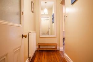 a hallway with a door with a bench and a window at Little Net House - Pittenweem in Pittenweem +21 photos