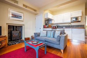 a living room with a couch and a table at Little Net House - Pittenweem in Pittenweem