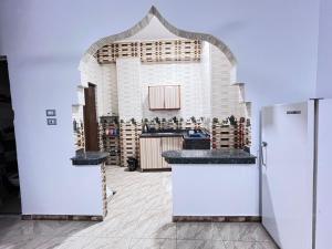 a kitchen with two sinks and a refrigerator in a room at Anas Nubian Guest House in Aswan