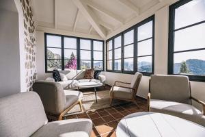 a waiting room with couches and chairs and windows at Posada del Marqués I A Slow Design Hotel in Esporles