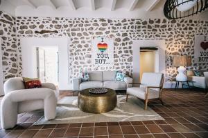 ein Wohnzimmer mit Sofa, Stühlen und einem Tisch in der Unterkunft Posada del Marqués I A Slow Design Hotel in Esporles