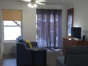 a living room with a blue couch and a tv at STUDIO SAINT-ROCH in Quebec City
