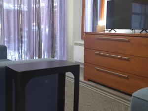 a living room with a dresser and a tv at STUDIO SAINT-ROCH in Quebec City