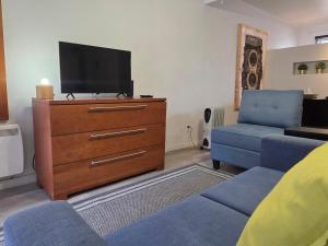 a living room with a dresser with a tv and a couch at STUDIO SAINT-ROCH in Quebec City