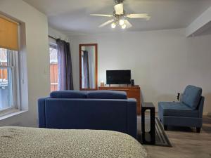 a living room with a blue couch and a chair at STUDIO SAINT-ROCH in Quebec City +36 photos