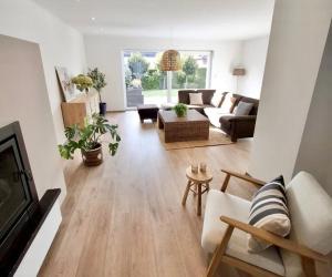 a living room with a couch and a table at Green& Light House16 in Kettenis