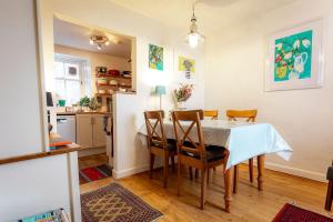 a kitchen and dining room with a table and chairs at Harbour View Apartment - Crail in Crail