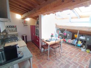 a kitchen with a table and chairs in a room at Casa via dei Longini in Città di Castello