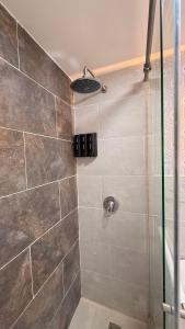 a bathroom with a shower with a glass door at CASA CIELO Quindio in Armenia