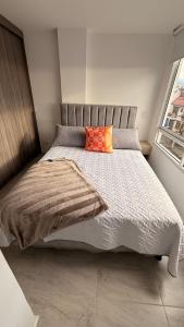 a bed with two pillows on it in a bedroom at CASA CIELO Quindio in Armenia