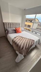 a bed in a room with a large window at CASA CIELO Quindio in Armenia