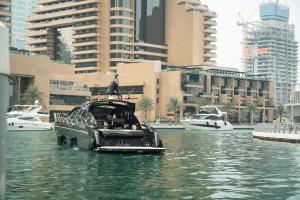 a small boat in the water in a city at Yacht Azimut Atlantis 50 in Dubai